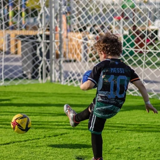 Young boy kicking a soccer ball